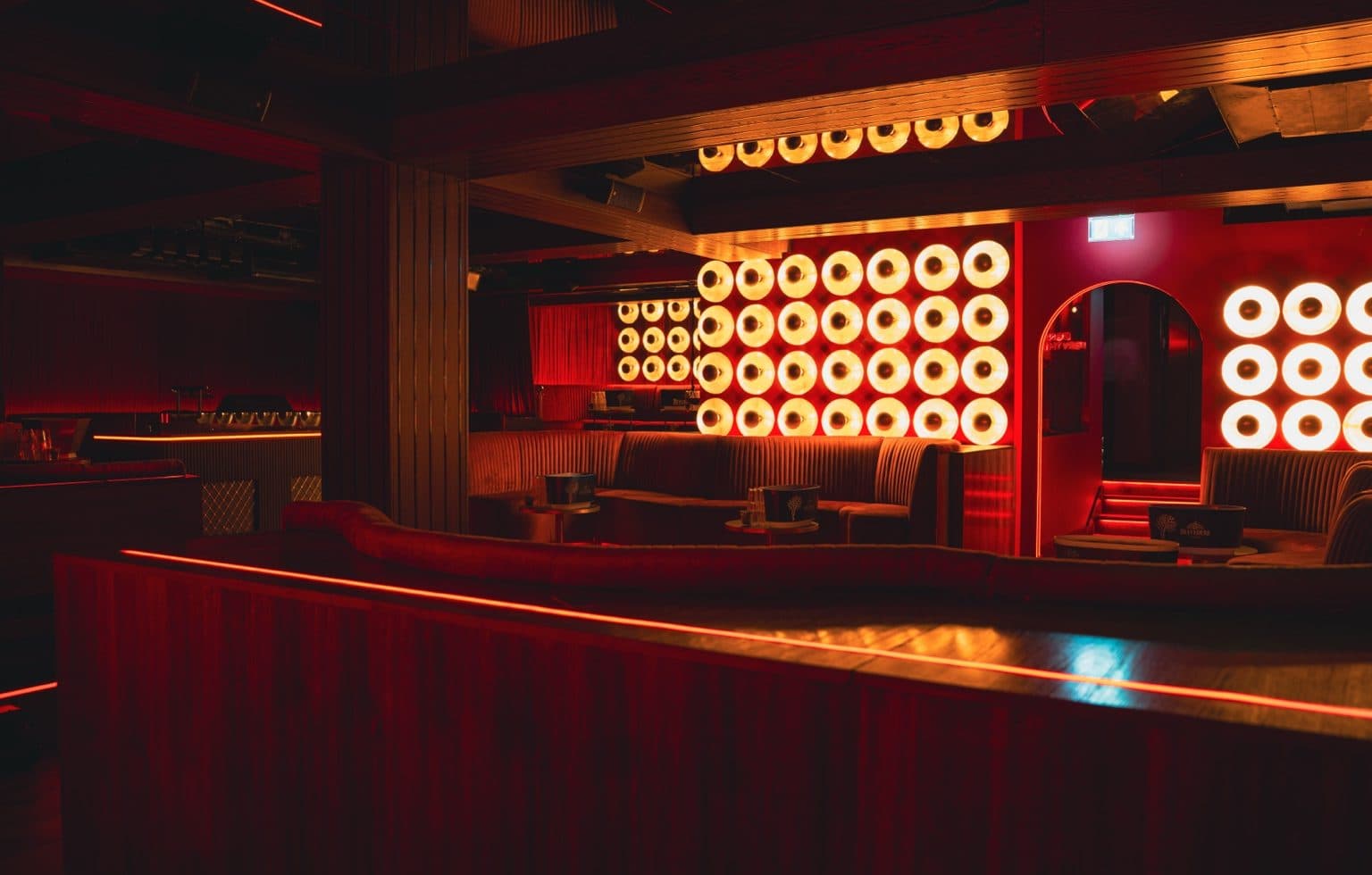 Rumour, Mayfair: the room seen across the bar to the disc walls and the arched doorway